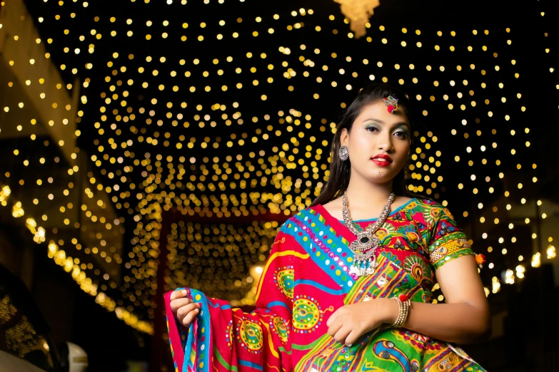 a woman wearing an orange and red sari