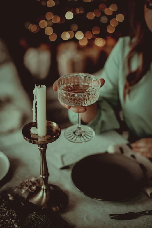 a candle is held between a plate with a small glass