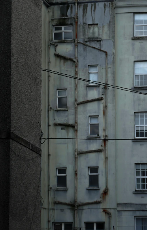 the scaffoldings on this building are made from various old materials