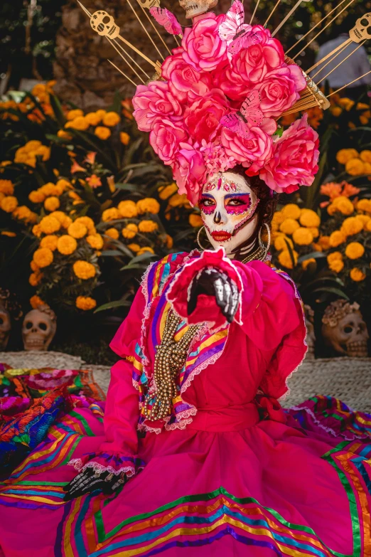 a skeleton woman in a pink dress and some flowers