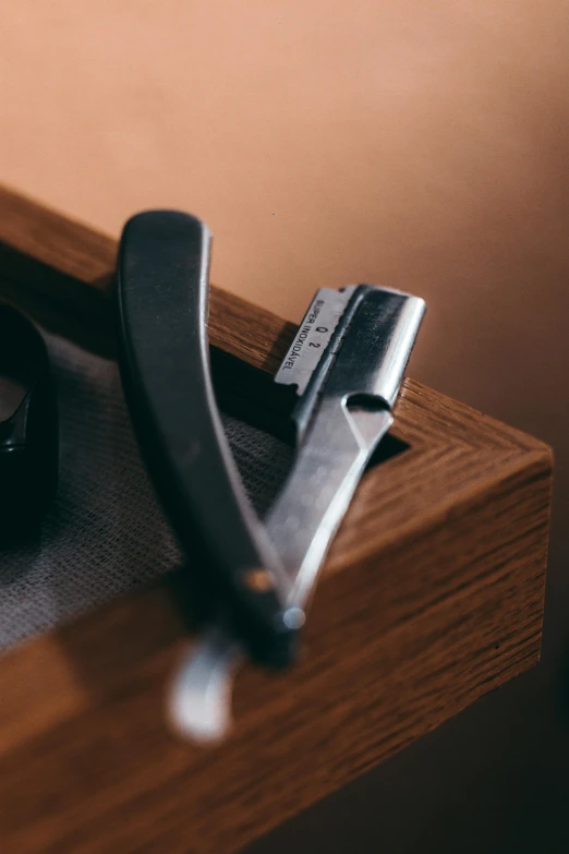 a pair of pliers sitting on top of a wooden table