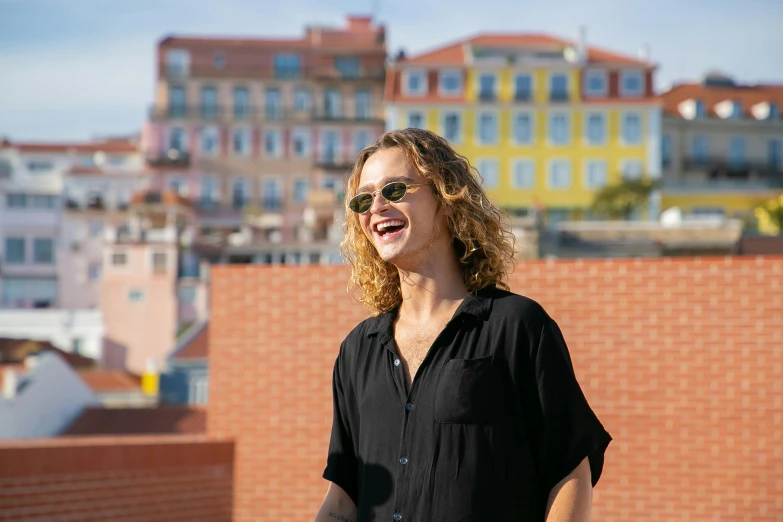 a man is standing outside by some buildings