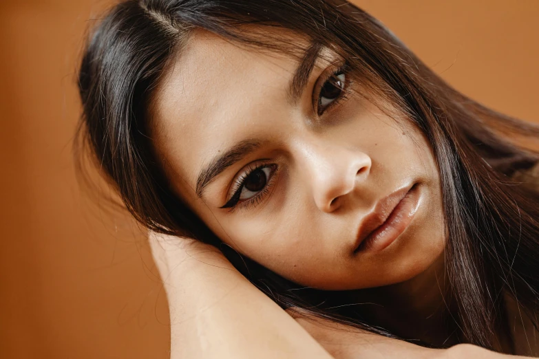 a girl with dark brown hair posing for a po