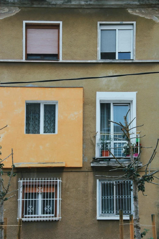 an apartment building with balcony and two small white windows