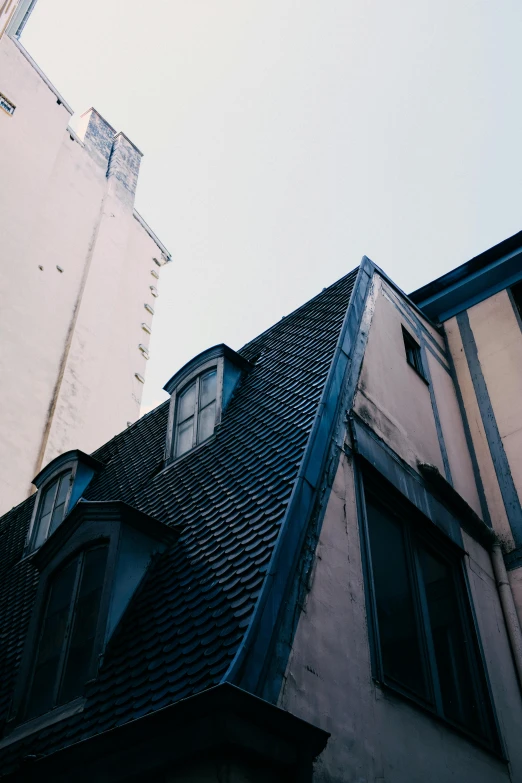 a view from the ground of a building and other buildings