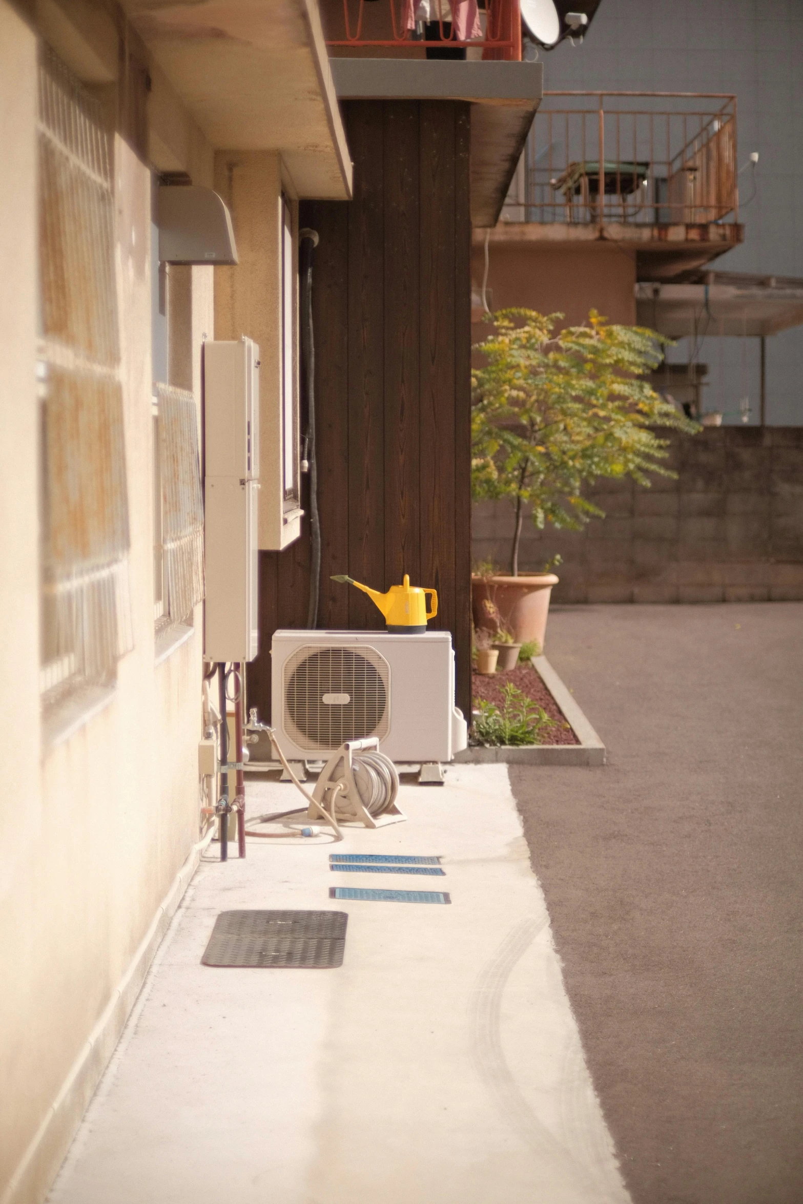 a small window air conditioner is on a porch