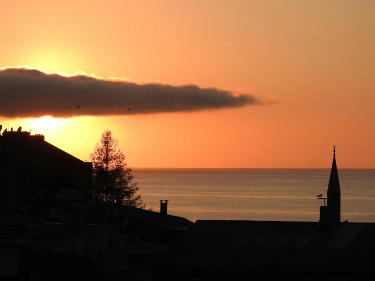 an orange sky that is over some buildings