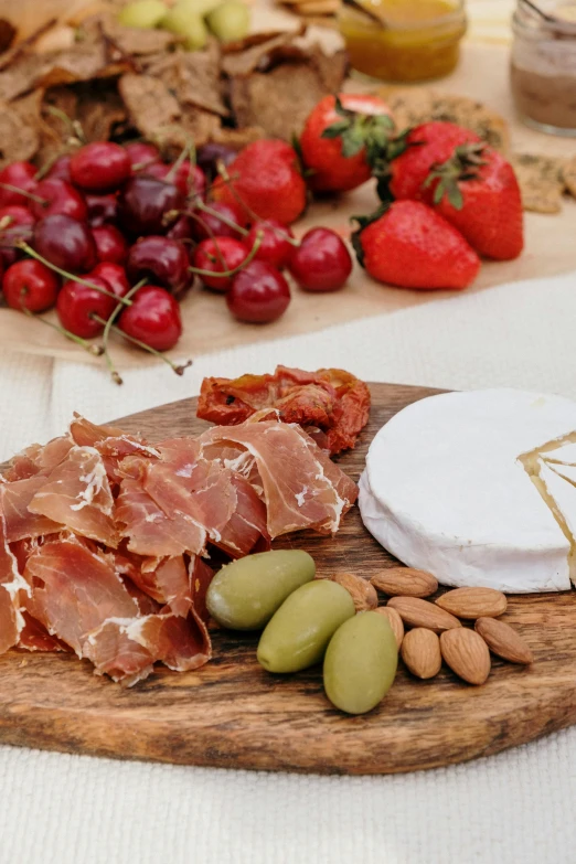 a wood tray holding ham and cheese