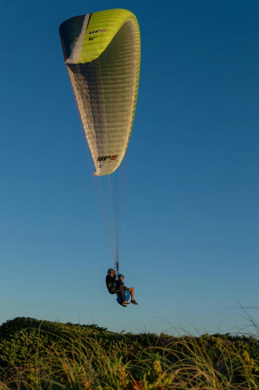 a person with a parachute being lifted by the sky