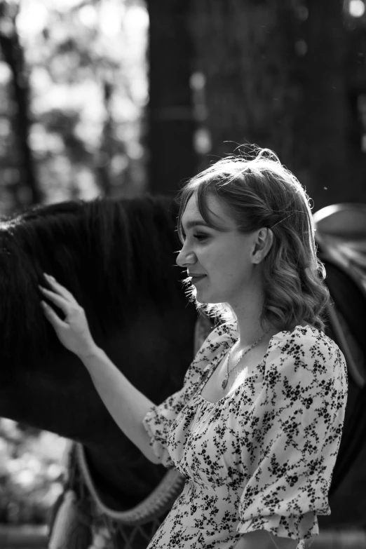 a woman smiles and holds the reigns to her horse