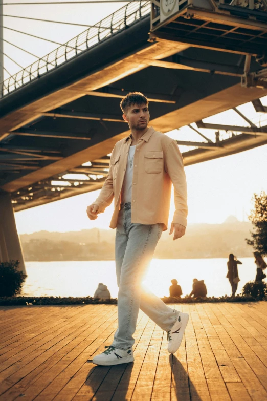 a man walking on the boardwalk with a clock tower in the background