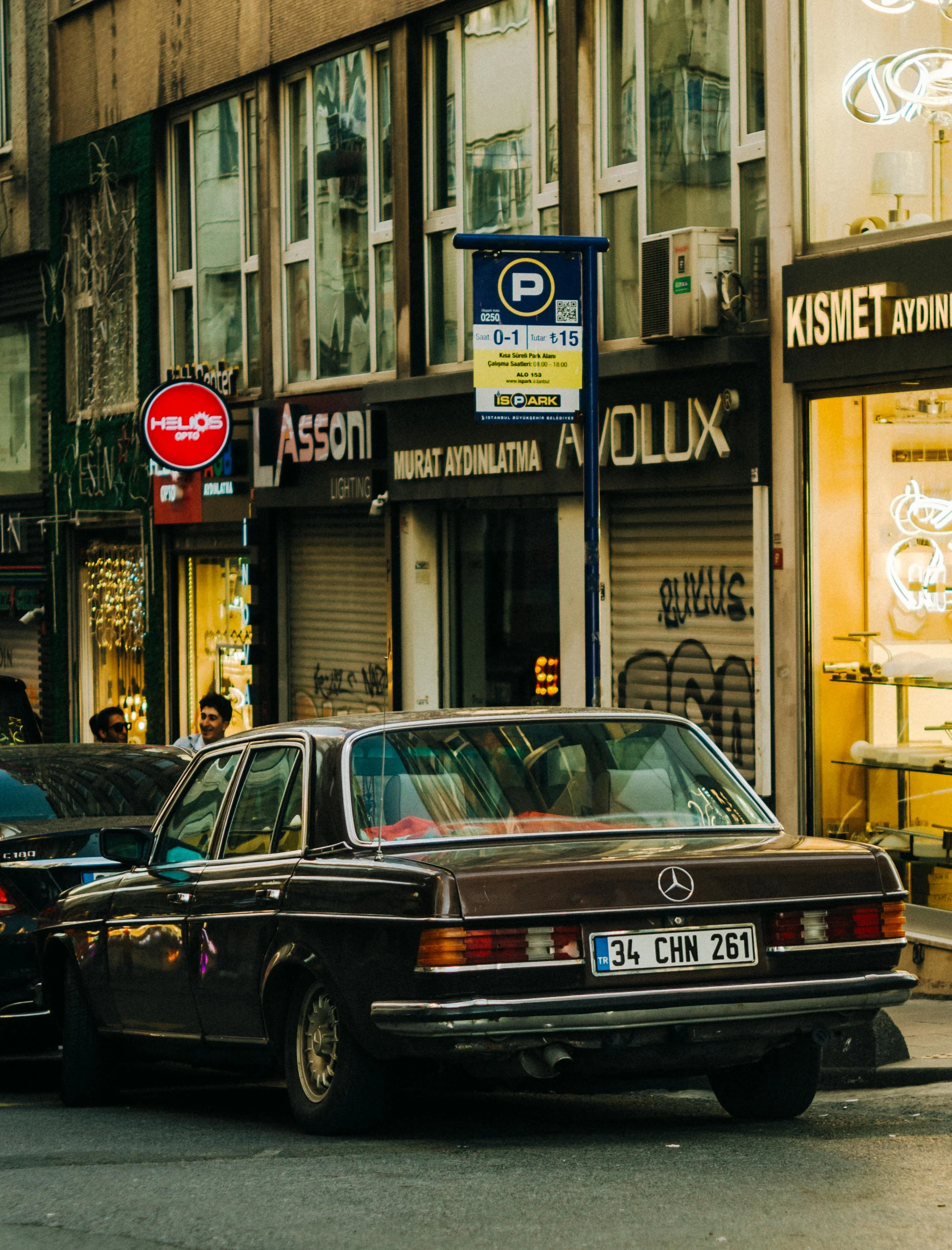 two mercedes benzs parked in front of a store front