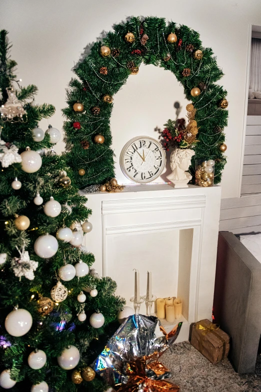 the christmas tree is next to a decorated mantle