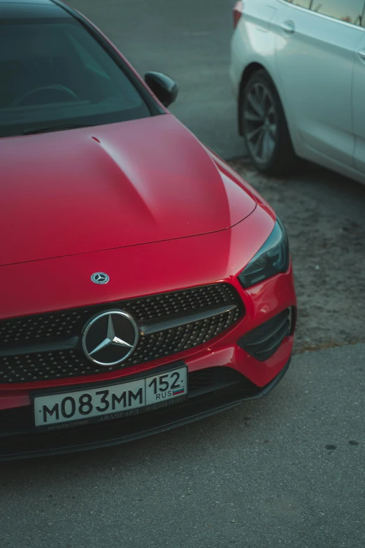 a mercedes benz coupe on the street with cars around