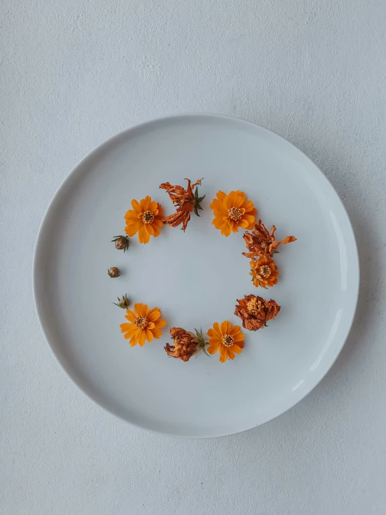 a plate with flowers on it sits on a table