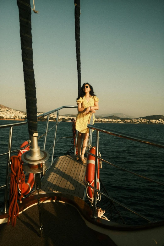 a woman standing on the side of a boat