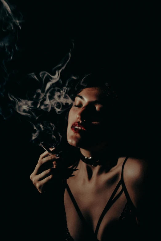 a woman wearing a  smoking a cigarette
