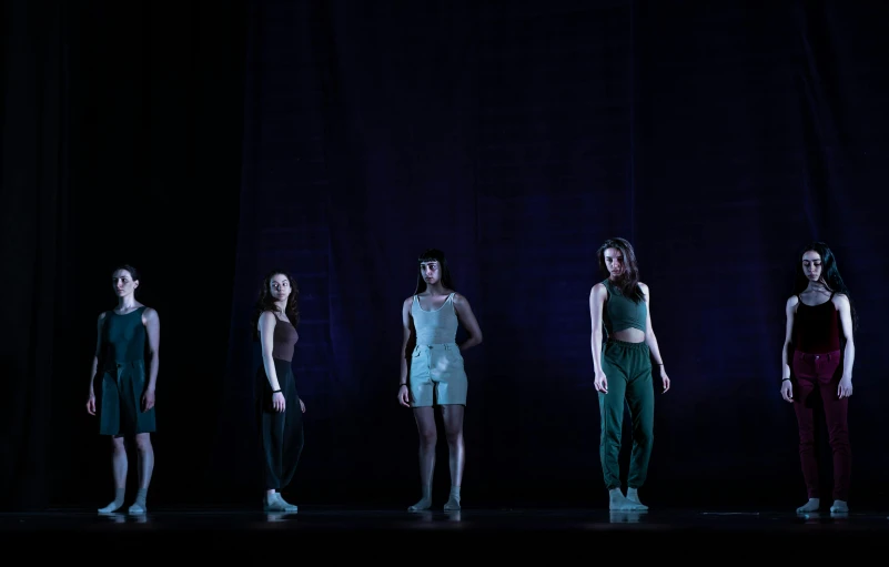 a row of women wearing short and tight outfits