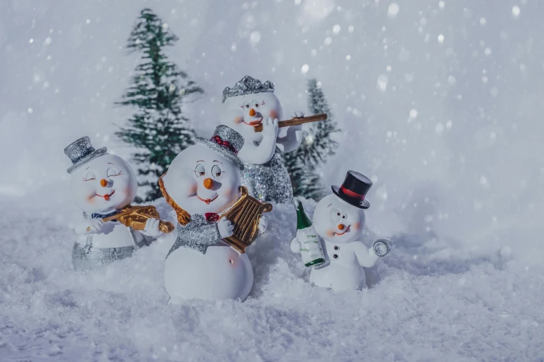 snowmen with various hats and hats, are standing in the snow