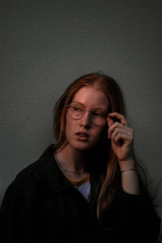 a woman with glasses posing for the camera