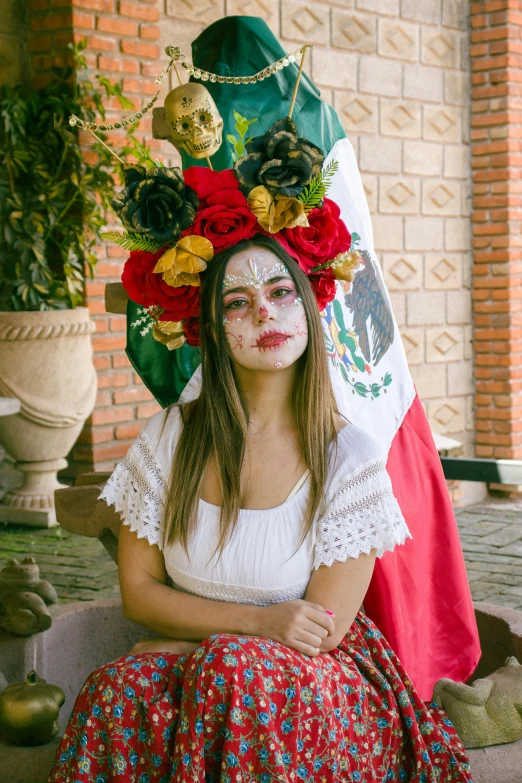 a woman in white and flowers on her face is posing