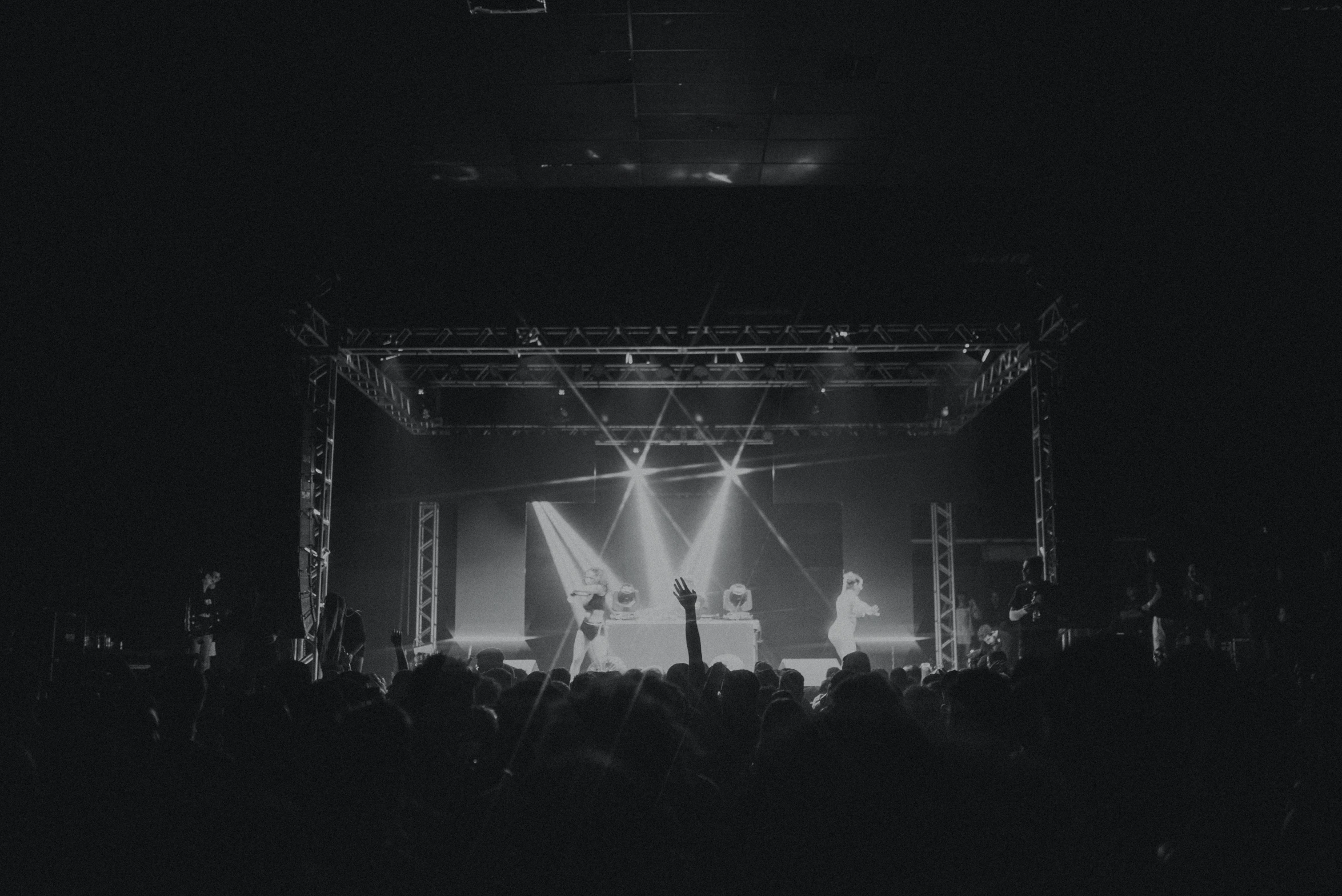 concert lights shining down on a crowd