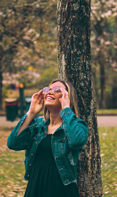 the woman is taking a picture and smiling