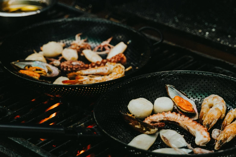 the seafood dish is cooking in the woks