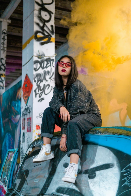 a woman with long hair and glasses on a skateboard