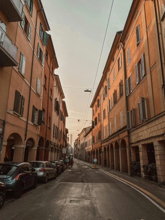 cars are parked in a row along an alley way