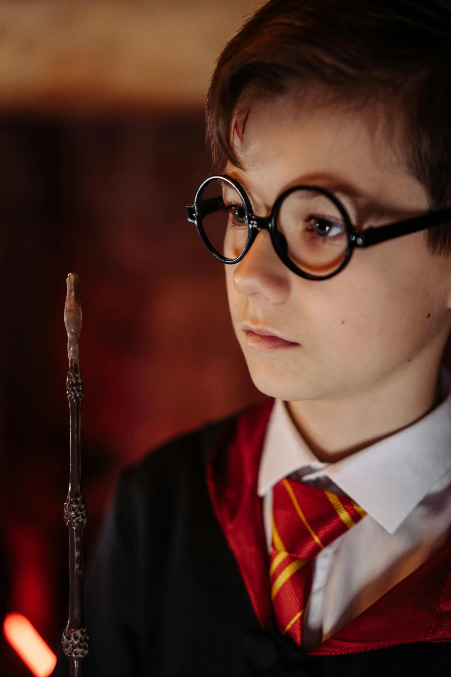 a young person with glasses and a harry potter outfit