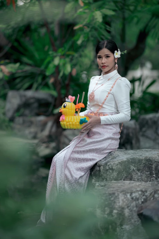 a woman holding a cake with a dragon on it