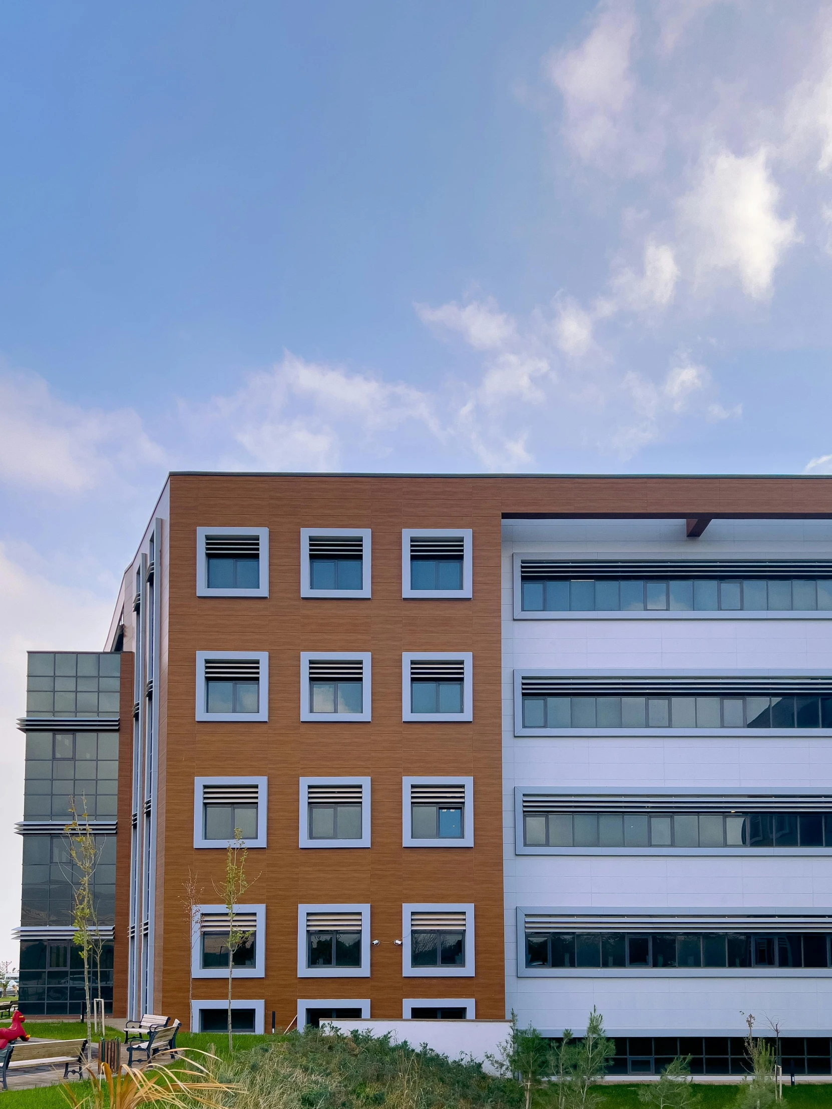 a tall building next to an orange and grey building