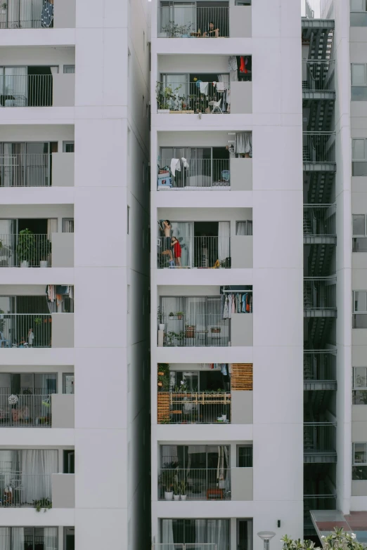 multiple balconies with plants in them on a large building