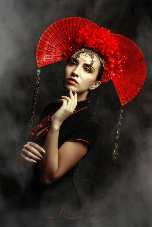 a woman with a red fan is posing