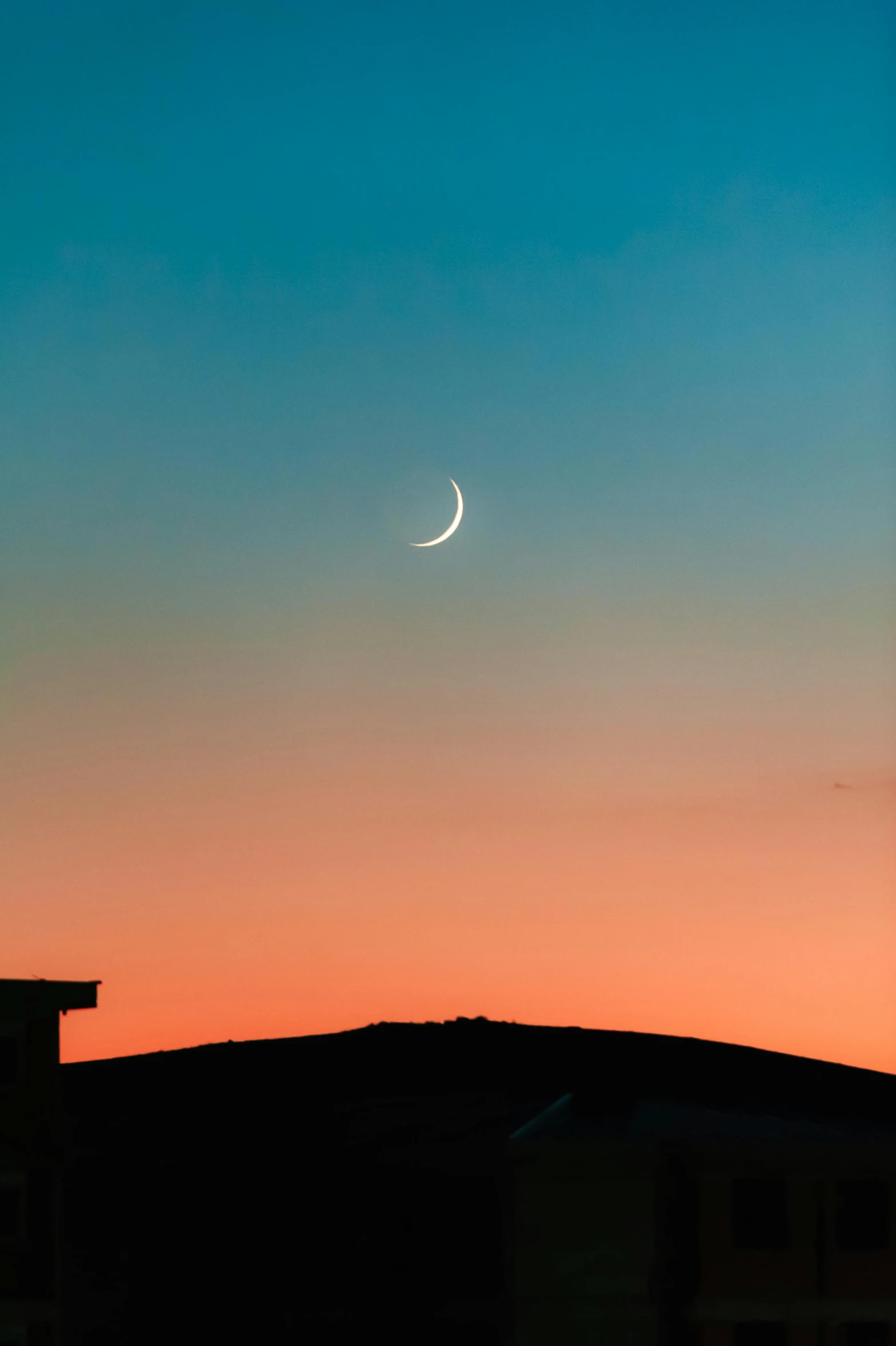 a crescent with a moon on a sky background