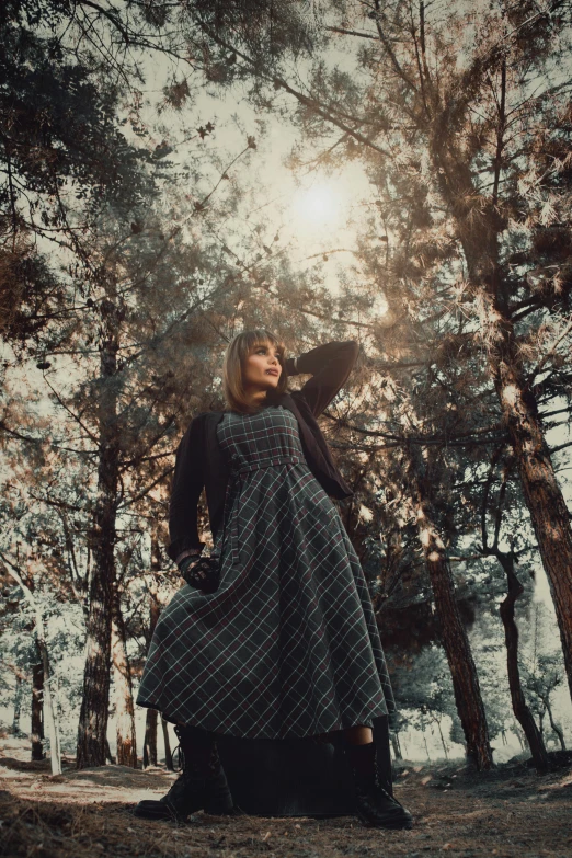 a woman with long hair posing in a forest