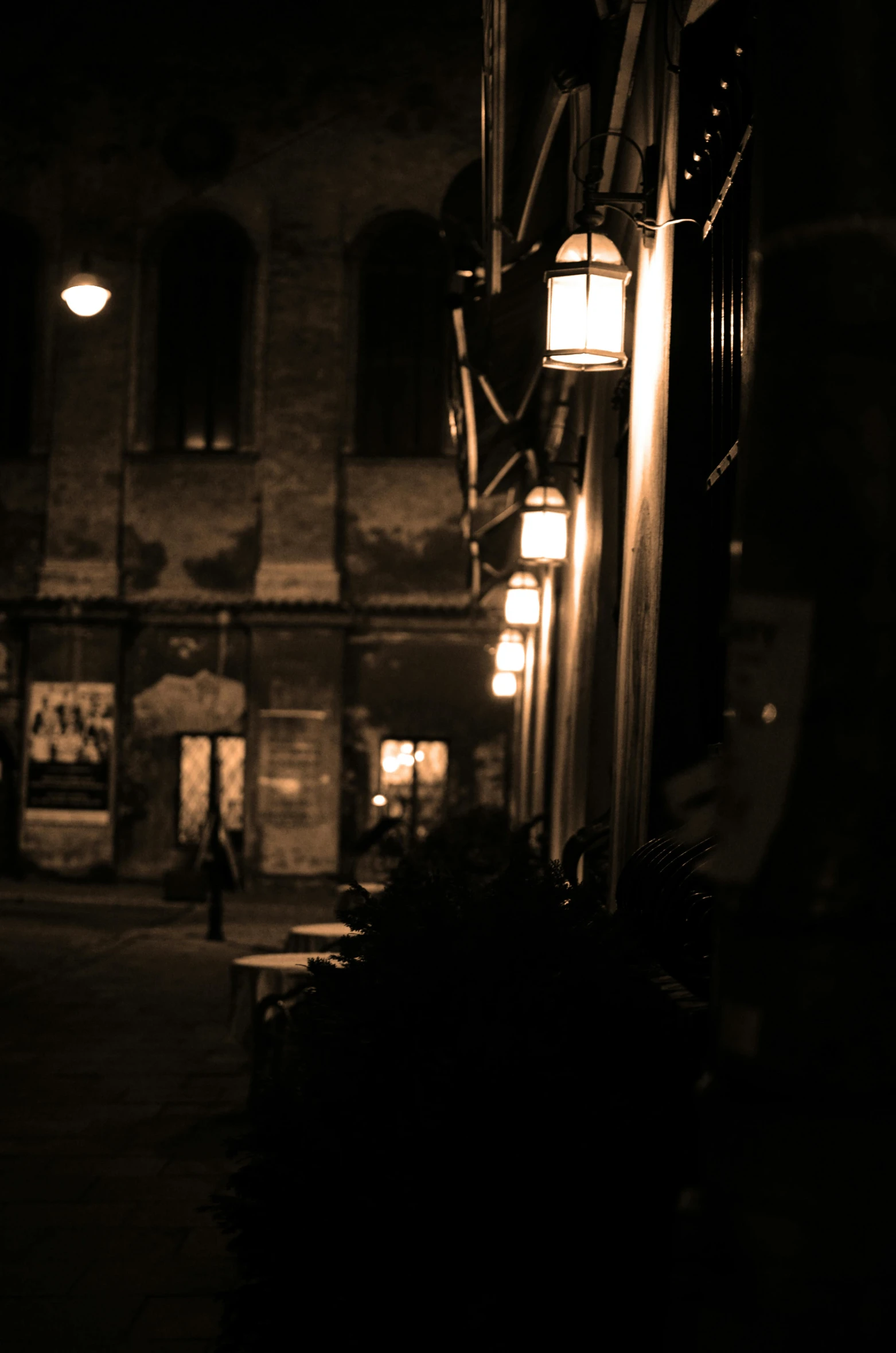 a night time street scene with a building and lit up lights