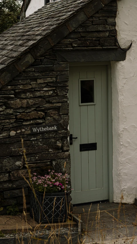 a green door that is next to a building