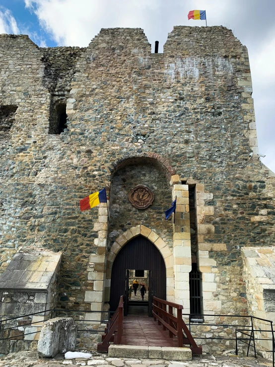 the entrance to an old building with lots of flags