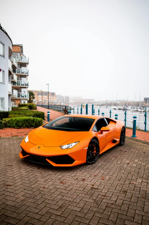 a bright orange lamb person parked in front of a building