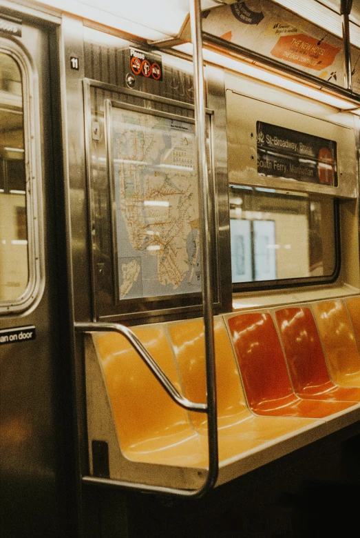 the seats on the subway car are tan and red