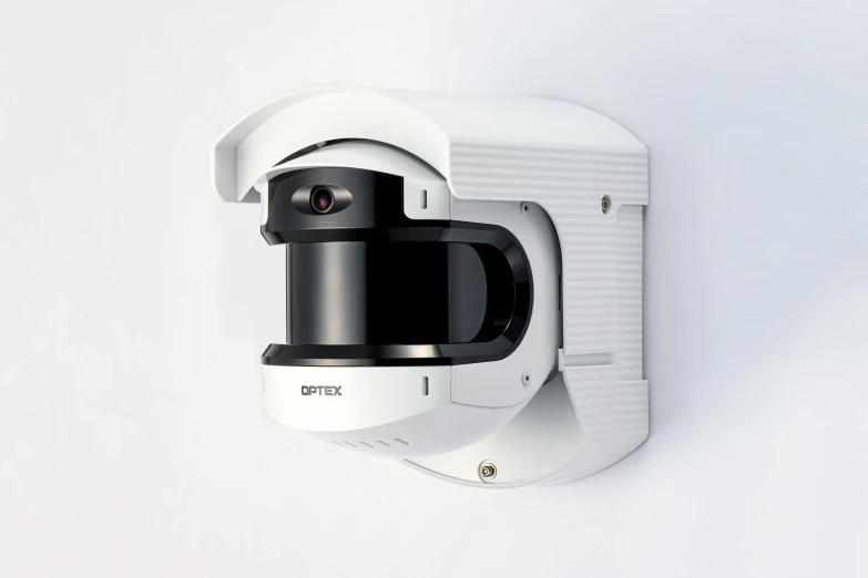 a camera attached to the wall of a white room