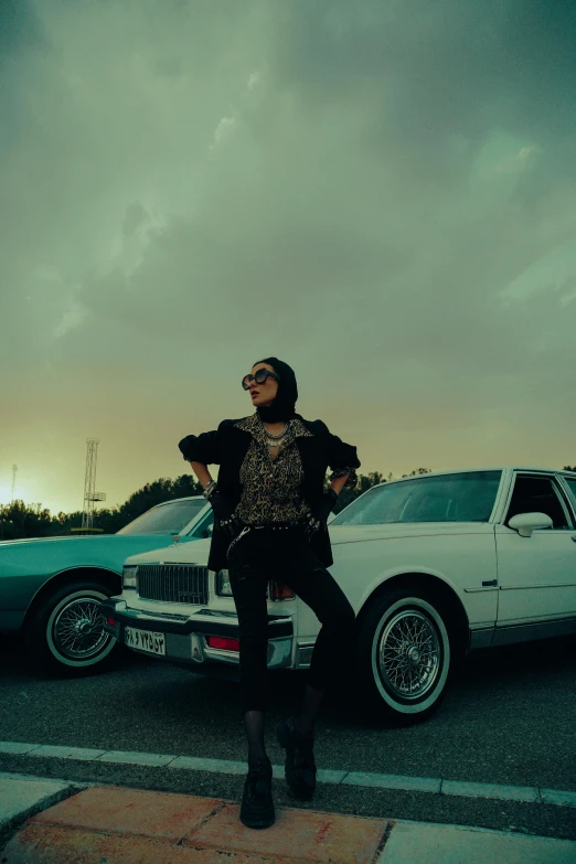 a man standing on the back of a parked car