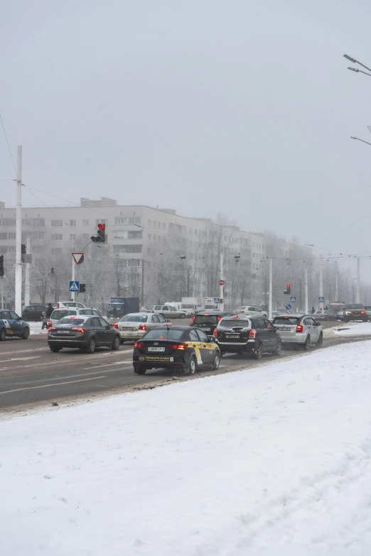 a snowy city street with traffic light on it