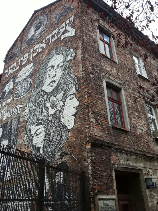 a brick building with a large mural on it