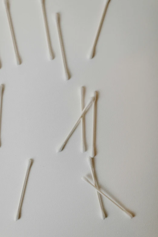 there are several toothpicks attached to strings together