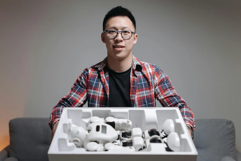 a man holding an assortment of cell phones