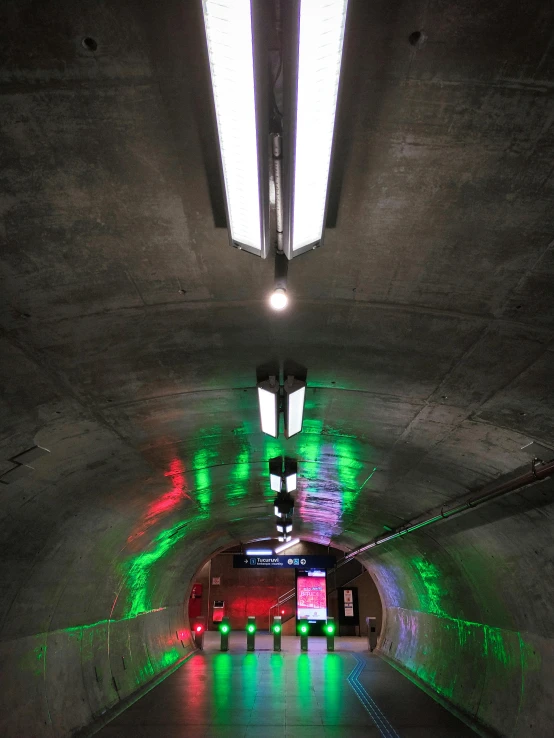 a light filled tunnel with multiple different colored lights on the wall