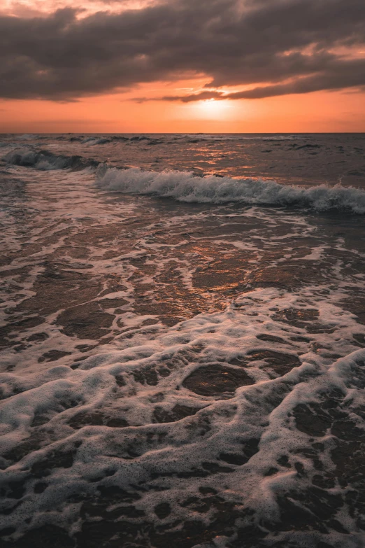 waves crashing and breaking on the shore of the beach